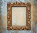 Golden carved antique frame on grunge worn wall Royalty Free Stock Photo