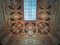 Golden ceiling with architectural details of the Salon Carre inside Louvre museum, Paris, France. Gilded ornaments with sculptures