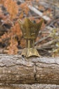 Golden censer incense burner on a wood log