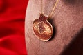 Golden chain with pomegranate shaped pendant, close-up Royalty Free Stock Photo