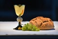 Golden chalice, bread and grapes. Royalty Free Stock Photo