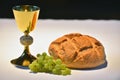 Golden chalice, bread and grapes. Royalty Free Stock Photo