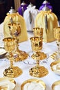 Golden chalices on the altar on top of a white table top Royalty Free Stock Photo