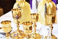 Golden chalices on the altar on top of a white table top Royalty Free Stock Photo