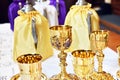 Golden chalices on the altar on top of a white table top Royalty Free Stock Photo