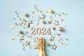 2024 golden champagne bottle christmas and New Year composition with party streamers, confetti stars and decorations. Flat lay Royalty Free Stock Photo