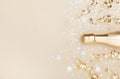 Golden champagne bottle with confetti stars and party streamers top view. Christmas, birthday or wedding background. Flat lay Royalty Free Stock Photo