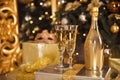 Golden Champagne bottle with two glasses. Christmas Celebration concept Royalty Free Stock Photo