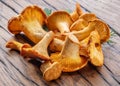 Golden chanterelle mushrooms on the old wooden table