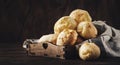 Golden Cheese buns in wooden tray, rustic kitchen table, copy space Royalty Free Stock Photo