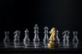 Golden chess knight is facing the silver opponent chess on black background. Leader, leadership, business strategy, challenge, Royalty Free Stock Photo