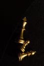 golden chess pieces lie on a black background top view Royalty Free Stock Photo