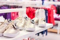 Children sneakers on the shelves in the store