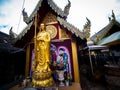 Golden Chinese Monk Statue Standing in Thai Temple Royalty Free Stock Photo