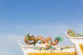 Golden Chinese stucco art on the roof of a Chinese temple on the sky background Royalty Free Stock Photo