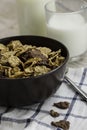 Golden and chocolate cornflakes in a bowl and a glass of milk on the wooden table Royalty Free Stock Photo