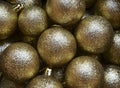 Golden Christmas balls as a background.Fir tree toys festive decoration.Winter holidays,Merry Christmas,Happy New Year concept.