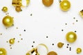 Golden Christmas balls, small sparkles, confetti and ribbons on a white background top view. Christmas decor, New Years Royalty Free Stock Photo