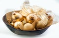 Golden Christmas baubles in a bowl Royalty Free Stock Photo