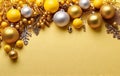 golden christmas baubles Christmas decorations on a yellow background with space for copy Royalty Free Stock Photo