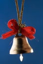 Golden Christmas bell with red ribbons Royalty Free Stock Photo