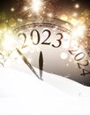 Golden Christmas clock showing 2023 in snowdrift