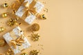 Golden Christmas decorations, gift boxes, balls, confetti on yellow background. New Year or Christmas postcard or greeting card.