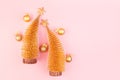 Golden christmas decorations with christmas trees, stars, balls on soft light pink background, copy space, top view. Royalty Free Stock Photo