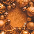 Golden Christmas frame. Christmas balls, stars, cones and hearts on golden sparkles background. Flat lay. Top view. Copy space. Royalty Free Stock Photo