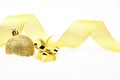 Golden christmas gift,bauble with golden ribbon on snow