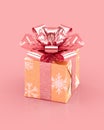 Golden Christmas gift box with sparkling pink bow and ribbons Royalty Free Stock Photo