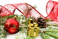 Golden christmas gifts,baubles with red ribbon and needles fir o Royalty Free Stock Photo