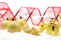 Golden christmas gifts,baubles red ribbon on snow Royalty Free Stock Photo