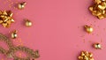 Golden Christmas party decorations, balls, confetti stars, carnival mask on pastel pink background. Christmas party or masquerade Royalty Free Stock Photo