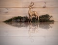 Golden, Christmas reindeer with a reflection in the floor. Royalty Free Stock Photo