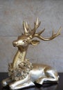 Golden Christmas reindeer sitting looking left Royalty Free Stock Photo