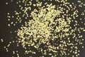 Golden Christmas stars on black background. Golden glitter texture abstract background. Royalty Free Stock Photo