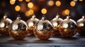 Golden Christmas tree balls on a wooden table, side view Royalty Free Stock Photo