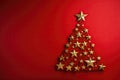 Golden Christmas tree on red background. Copy space. New Year concept. Royalty Free Stock Photo