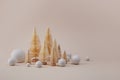 Golden christmas trees with snow ball on biege background. Minimal concept for winter hollydays. Royalty Free Stock Photo