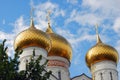 Golden church cupolas. Blue sky with clouds background.