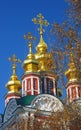 Golden church cupolas and crosses. Blue sky background.