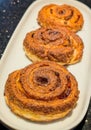 Golden Cinnamon Rolls with Raisins on White Plate Royalty Free Stock Photo