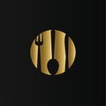 Golden circle with cutlery inside. Isolated logo on black background. Fork spoon and knife in negative circle space
