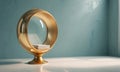 golden, circular side table with stack books on top stands against blue wall, casting shadow on the white Royalty Free Stock Photo