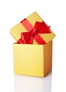 Golden classic shiny gift box with red satin bow Royalty Free Stock Photo