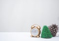 Golden clock and Christmas decoration on white background with copy-space, family spent time together in winter Christmas holiday Royalty Free Stock Photo