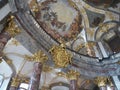 Golden coat of arms and ceiling painting in baroque court church in WÃ¼rzburg Residence, Germany