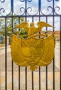 Golden coat of arms in a gate at the Presidential residence, Bog