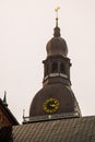 The Golden Cockerel on the clock tower.Riga Cathedral on Dome Square at the historical center in the old town of Riga, Latvia